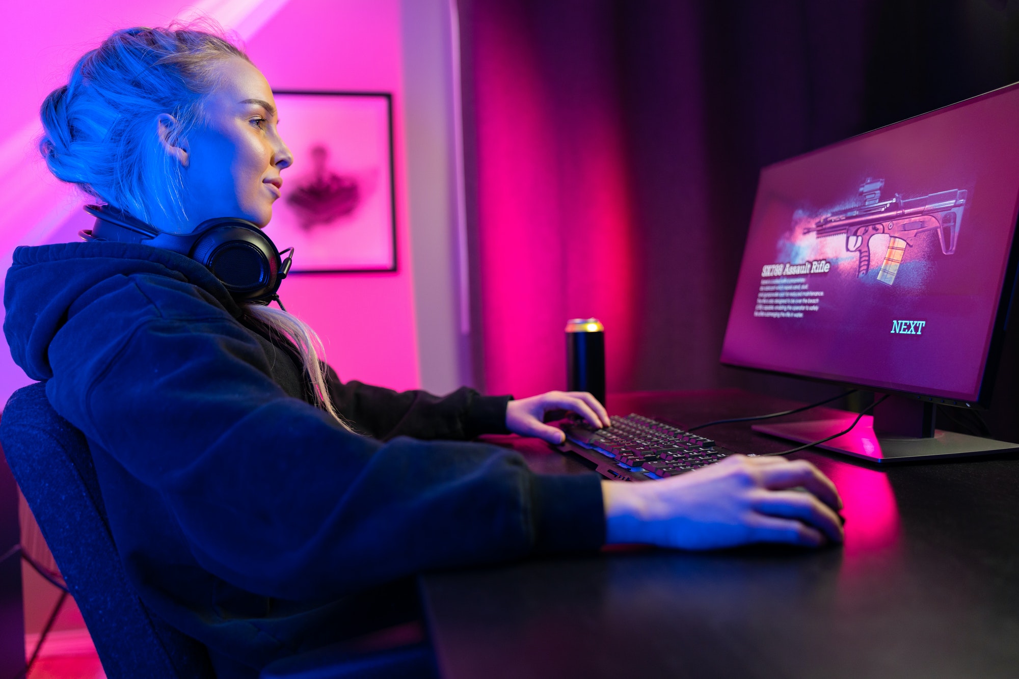 Professional gamer girl with headset play online multiplayer video game on PC